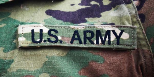 The US Army insignia appears on the uniform of an American soldier.